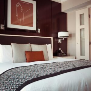Cozy and modern hotel bedroom interior with elegant decor and soft lighting.
